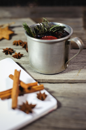 Traditional fruity mulled wine from the old mug, on an old wooden tableの写真素材