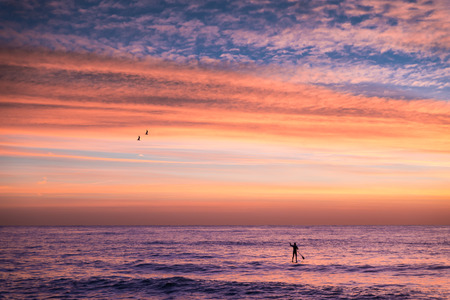 Man on Stand Up Paddle Board before suriseの写真素材