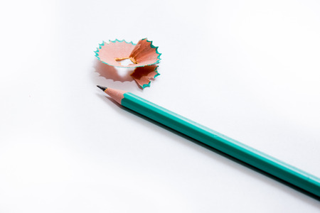 Green pencil and peelings isolated on whiteの写真素材