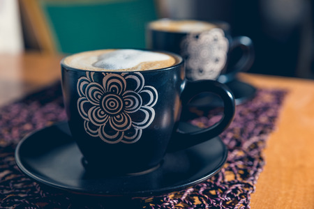 Two cups od cappuccino on the tableの写真素材