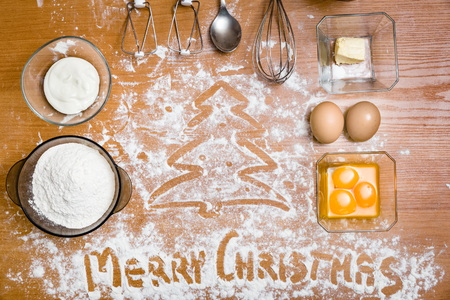 cake ingredients, egg beater, eggs, cream and flour. Merry Christmasの写真素材