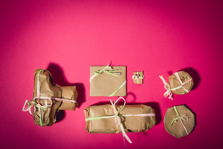 Photographer's gift wrapped with brown paper. Camera, lens, flash lamp, tripod. Copy space. Photography conceptの写真素材