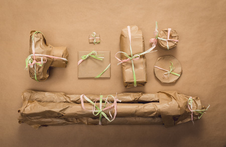Photographer's gift wrapped with brown paper. Camera, lens, flash lamp, tripod. Photography conceptの写真素材