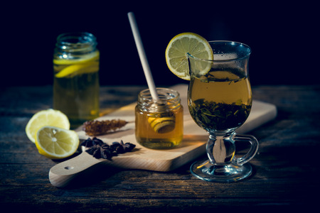 Natural medicones against flue and cold. Honey, lemon, hot tea, onion and garlic. Health concept.の写真素材