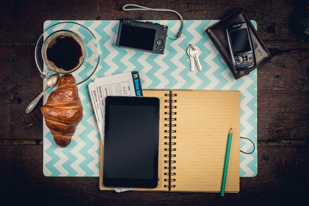 Journey staff on the desktop: notepad, tikets, wallet, coffee and cameraの写真素材