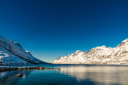 Norwegian fjords and snowy mountains in winterの写真素材