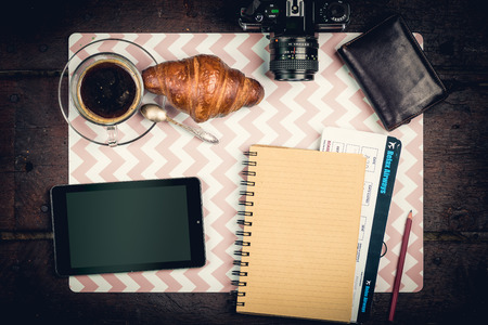 Journey staff on the desktop: notepad, tikets, wallet, coffee and cameraの写真素材