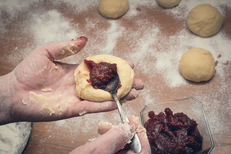 Woman's hands preparing home made doughnuts. Fat thursday conceptの写真素材