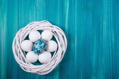 Flat lay view of painted and white easter eggs.