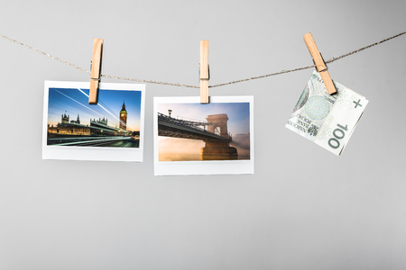Two photograph and one bank note hungning on the stringの写真素材