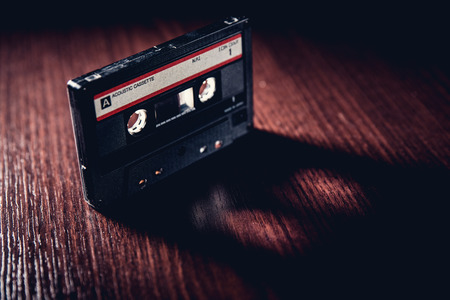 Old-fashioned cassette tape on the dark surfaceの写真素材