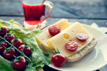 Swiss yellow cheese sandwich with cherry tomtoesの写真素材