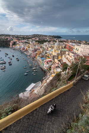 View of beautiful Procida in sunny summer day. Colorful houses, cafes and restaurants, fishing boats and yachts in Marina Corricella,の写真素材