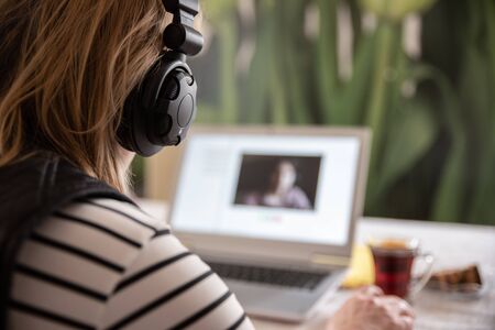 Home office. Woman working at home doing video chat.の写真素材
