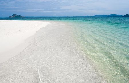 Deserted tropical beach with blue skyの写真素材