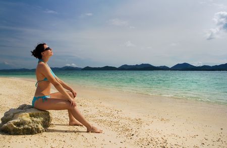 Girl relaxing on tropical beachの写真素材