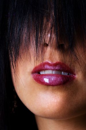 Beautiful lips with shiny lipstick on a young femaleの写真素材