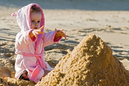 Child reaching out on the beachの写真素材