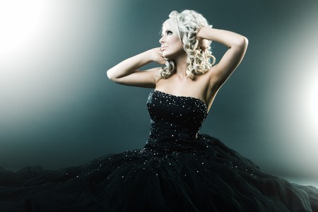 High fashion woman in sexy pose and  large formal dressの写真素材