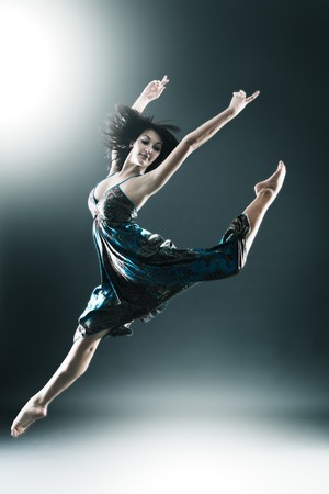 Stylish and young modern style dancer is jumping stretchedの写真素材