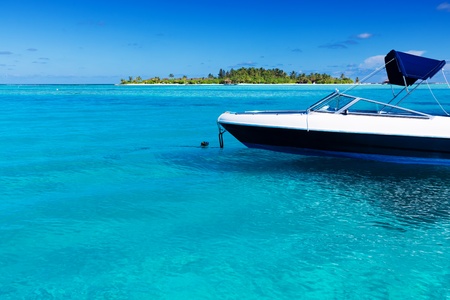 Boat in perfect tropical lagoon with island in backgroundの写真素材