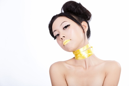 Asian model with yellow lips and neck strip and creative hairの写真素材