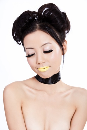 Young asian female with creative yellow colorful makeupの写真素材