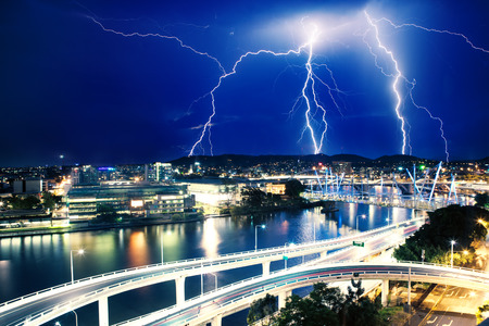 Multiple eletric lightning strikes over river in Brisbane, Queensland, Australiaの写真素材