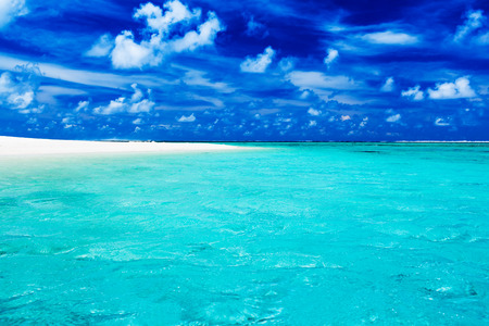 Deserted tropical beach with clear blue water and skyの写真素材