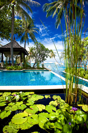 Outdoor tropical massage gazebo on the beach next to swimming poolのeditorial素材