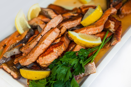 Close up of stakes from a salmon with lemon on a plateの写真素材