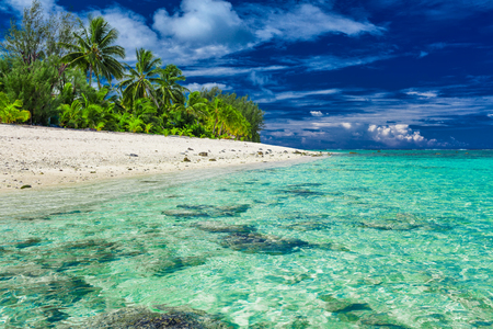 Amazing beach with white sand and black rocks on Rarotonga, Cook Islandsの写真素材