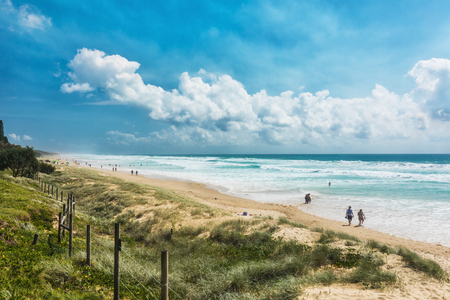 COOLUM, AUSTRALIA, FEB 18 2018: People enjoying summer at Coolum main beach - a famous tourist destination in Queensland, Australia.のeditorial素材