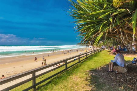COOLUM, AUSTRALIA, FEB 18 2018: People enjoying summer at Coolum main beach - a famous tourist destination in Queensland, Australia.のeditorial素材