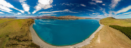 Aerial drone shots of beautiful Lake Tekapo with reflection of sky and mountains, New Zealandの写真素材