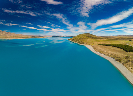 Aerial drone shots of beautiful Lake Tekapo with reflection of sky and mountains, New Zealandの写真素材