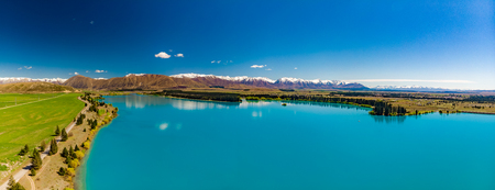 Lake Ruataniwha, New Zealand, South Island, trees and mountains, water reflectionsの写真素材
