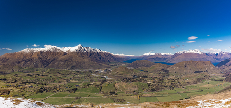 New Zealand mountain panorama and snow ski slopes as seen from Coronet Peak ski resort, Queenstownの写真素材