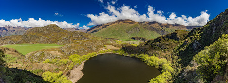 Rocky Mountain and Diamond Lake in the Mt Aspiring National Park near Wanaka, New Zealandの写真素材