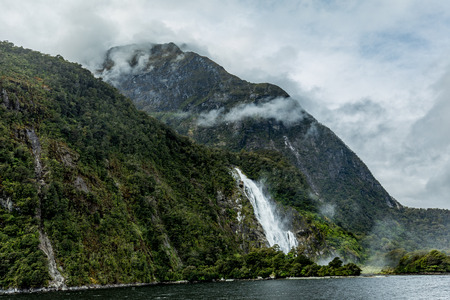 Cloudy and rainy day at amazing and vibrant Milford Sound, South Island, New Zealandの写真素材