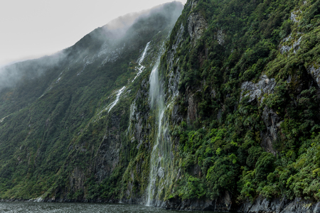 Cloudy and rainy day at amazing and vibrant Milford Sound, South Island, New Zealandの写真素材