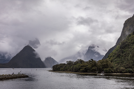 Cloudy and rainy day at amazing and vibrant Milford Sound, South Island, New Zealandの写真素材