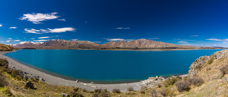Beautiful Lake Tekapo with reflection of sky and mountains, New Zealandの写真素材