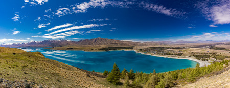 Beautiful Lake Tekapo with reflection of sky and mountains, New Zealandの写真素材