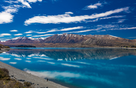 Beautiful Lake Tekapo with reflection of sky and mountains, New Zealandの写真素材