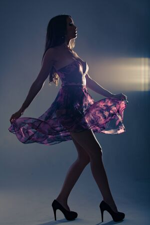Fashion photo of young beautiful lady in elegant purple party dressの写真素材
