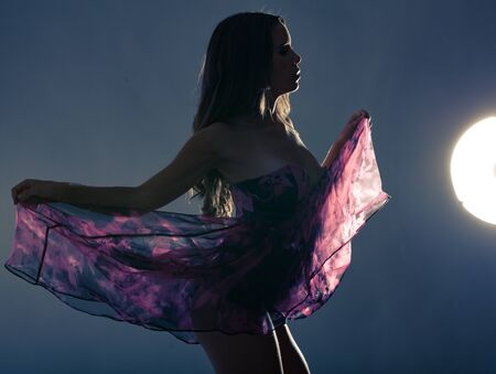 Fashion photo of young beautiful lady in elegant purple party dressの写真素材
