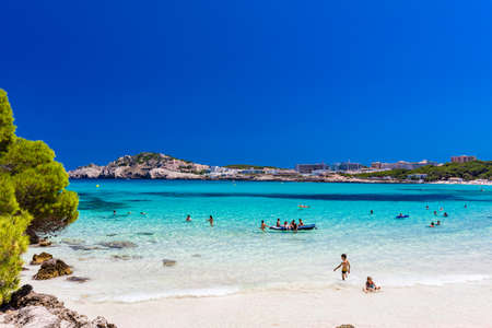 CALA AGULLA, MALLORCA, SPAIN - 21 July 2020: People enjoying summer on the popular sand beach on Mallorca,  Balearic Islands.のeditorial素材