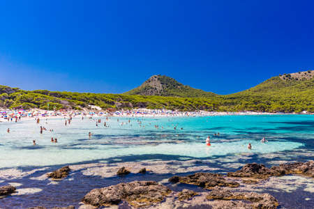 CALA AGULLA, MALLORCA, SPAIN - 21 July 2020: People enjoying summer on the popular sand beach on Mallorca,  Balearic Islands.のeditorial素材