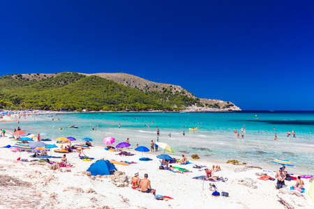 CALA AGULLA, MALLORCA, SPAIN - 21 July 2020: People enjoying summer on the popular sand beach on Mallorca,  Balearic Islands.のeditorial素材